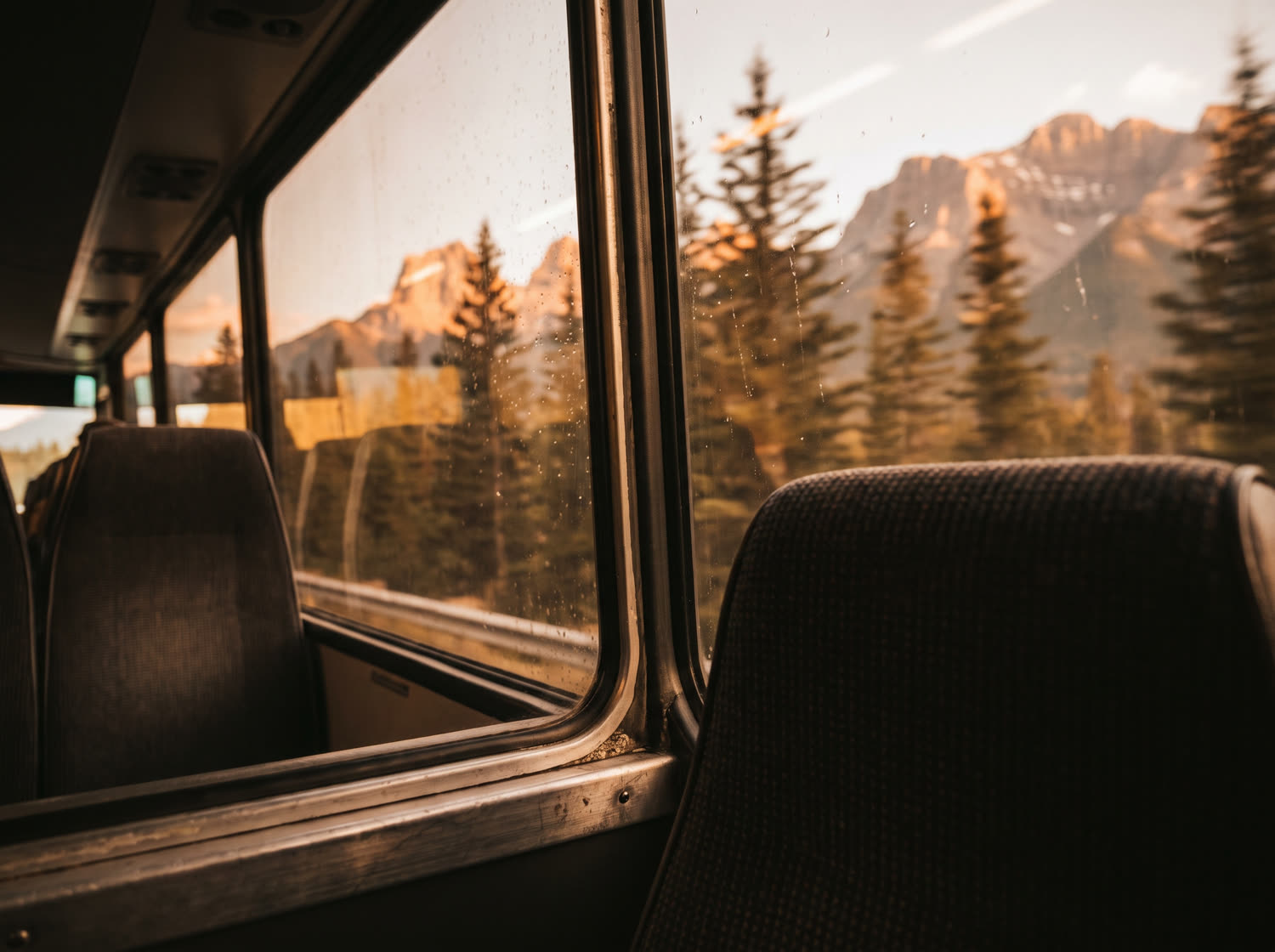 Looking out at the Rockies from a coach window at golden hour