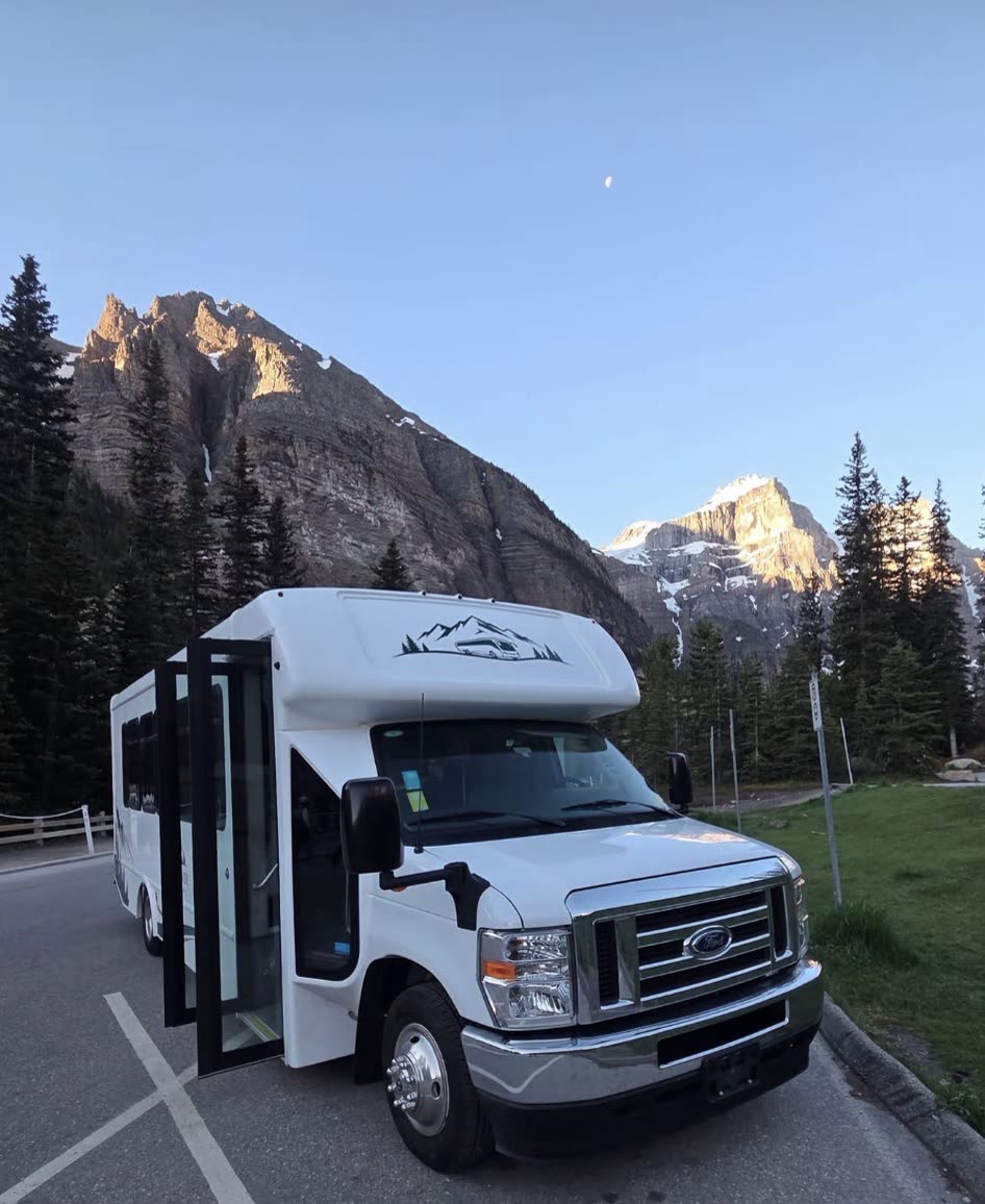 The RockFlower coach parked in the mountains at golden hour