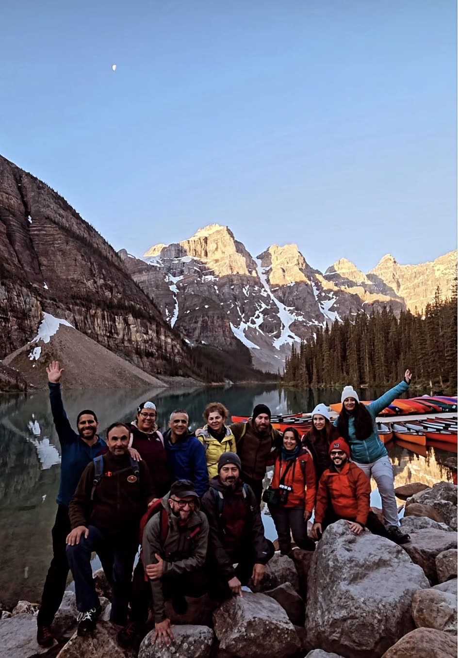 A RockFlower group together at the lake at sunrise